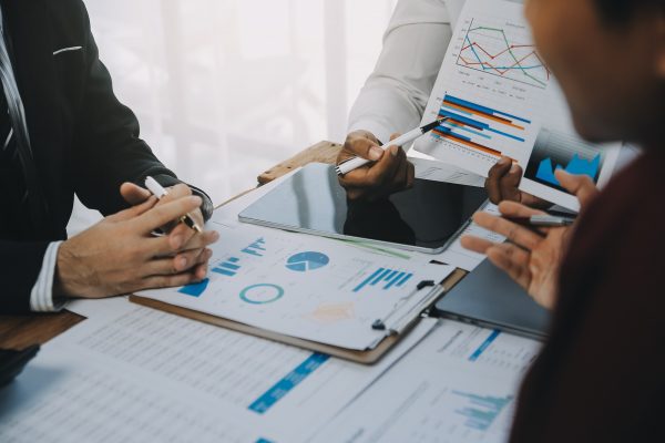 Business team working with new startup project plan and discussion information for financial strategy with laptop and digital tablet in a modern business lounge.